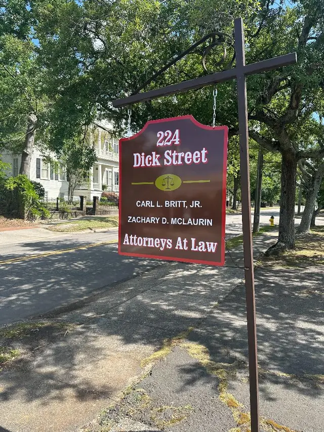 The firm's hanging sign at 224 Dick Street under the oaks, Fayetteville